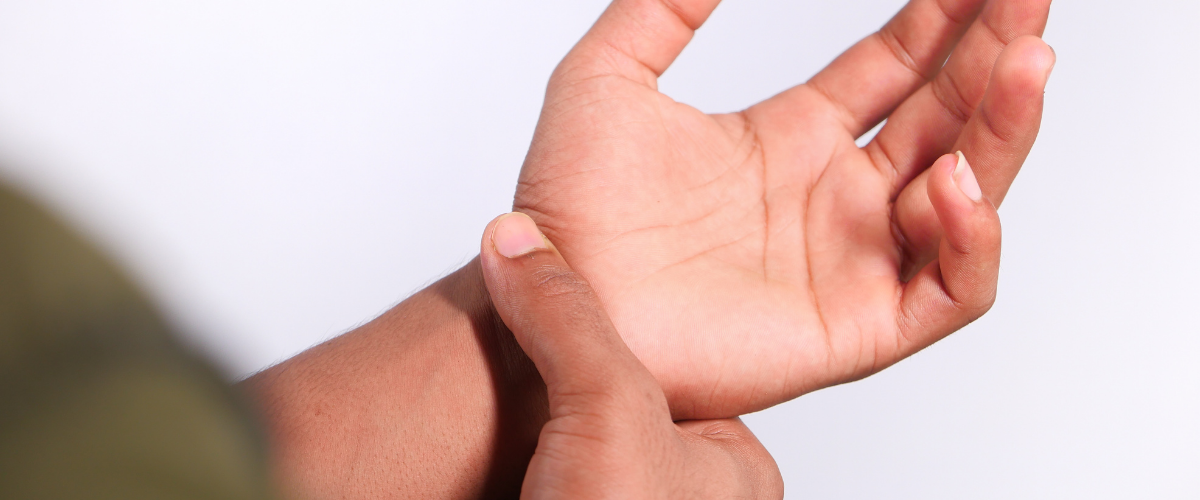 Scientist with repetitive motion injury rubs hands together in pain